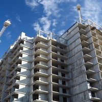 Construction of building. Beautiful sky background.