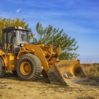 day view of yellow excavator with shovel after work